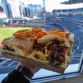 A Four Bagger hamburger is shown at Truist Park before a baseball game between the Texas Rangers and the Atlanta Braves Sunday, April 21, 2024, in Atlanta. The culinary game at MLB ballparks has exploded in the past 20 years. Eating healthy is a challenge. (AP Photo/John Bazemore)
