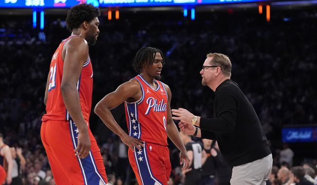 Philadelphia 76ers head coach Nick Nurse, right, talks to Tyrese Maxey, center, and Joel Embiid, left, during the second half of Game 2 in an NBA basketball first-round playoff series against the New York Knicks, Monday, April 22, 2024, in New York. (AP Photo/Frank Franklin II) **FILE**