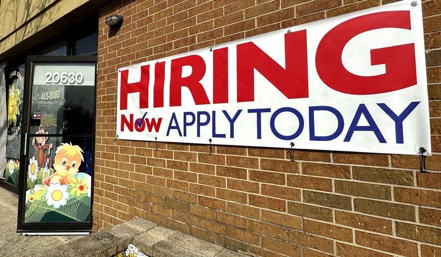 A hiring sign is displayed in Riverwoods, Ill., Tuesday, April 16, 2024. The Biden administration has finalized a new rule set to make millions of more salaried workers eligible for overtime pay in the U.S. The move marks the largest expansion in federal overtime eligibility seen in decades. (AP Photo/Nam Y. Huh, File)