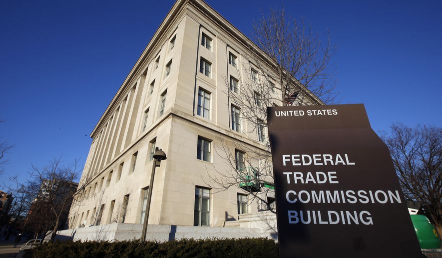 FILE - The Federal Trade Commission building is seen, Jan. 28, 2015, in Washington. U.S. companies would no longer be able to bar employees from taking jobs with competitors under a rule approved by the FTC on Tuesday, April 23, 2024, though the rule seems sure to be challenged in court. (AP Photo/Alex Brandon, File)