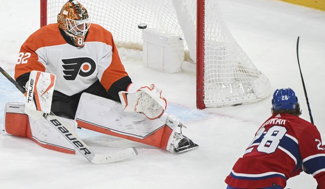 Montreal Canadiens&#x27; Christian Dvorak (28) scores against Philadelphia Flyers Ivan Fedotov goaltender during the second period of an NHL hockey game in Montreal, Tuesday, April 9, 2024. (Graham Hughes/The Canadian Press via AP)