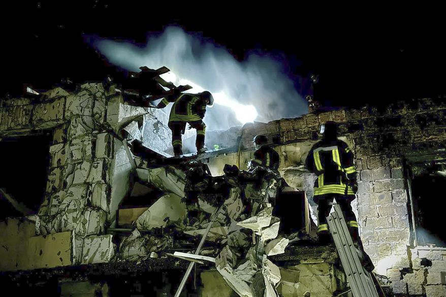 In this photo provided by the Mayor of Odesa Hennadii Trukhanov in Telegram, firefighters work on the site of a burning building after a Russian drone attack in Odesa, Ukraine, Tuesday, April 23, 2024. (Mayor of Odesa Hennadii Trukhanov via AP)