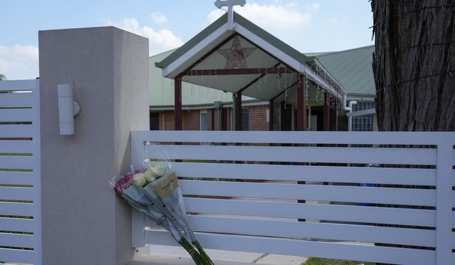 Flores sit on a fence outside the Christ the Good Shepherd church in suburban Wakely in western Sydney, Australia, on April 16, 2024. Detectives and secret service agents investigating the stabbing of a bishop in the Sydney church last week executed search warrants in the city on Wednesday, April 24, as part of a major operation, officials said. (AP Photo/Mark Baker, File)