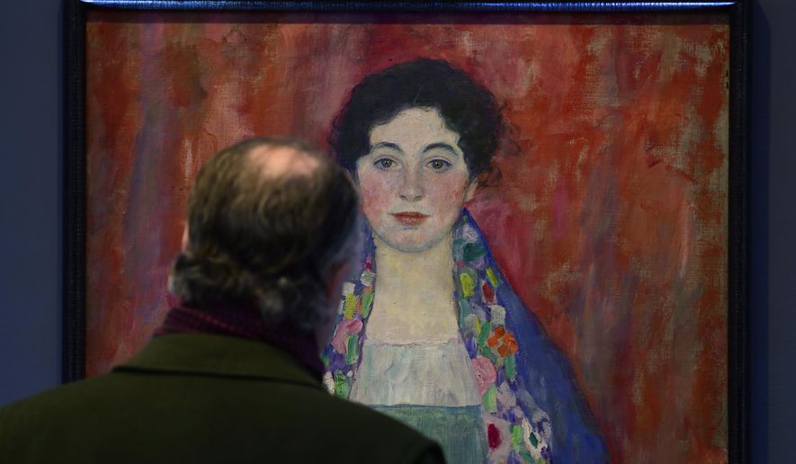 A man looks at the painting 'Portrait of Fräulein Lieser' by Austrian painter Gustav Klimt prior to an auction, in Vienna, Wednesday, April 24, 2024. A portrait of a young woman by Gustav Klimt that was long believed to be lost has been sold at an auction in Vienna for 30 million euros ($32 million). The Austrian modernist artist started work on the “Portrait of Fräulein Lieser” in 1917, the year before he died, and it is one of his last works. (AP Photo/Christian Bruna)