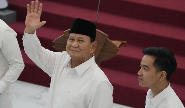 Indonesian Defense Minister and president-elect Prabowo Subianto, left, waves at media members as his running mate Gibran Rakabuming Raka, the eldest son of Indonesian President JokoWidodo, looks on during their formal declaration as president and vice president-elect at the General Election Commission building in Jakarta, Indonesia, Wednesday, April 24, 2024. Indonesia&#x27;s electoral commission formally Subianto as the elected president in a ceremony on Wednesday after the country&#x27;s highest court rejected appeals lodged by two losing presidential candidates who are challenging his landslide victory. (AP Photo/Dita Alangkara)