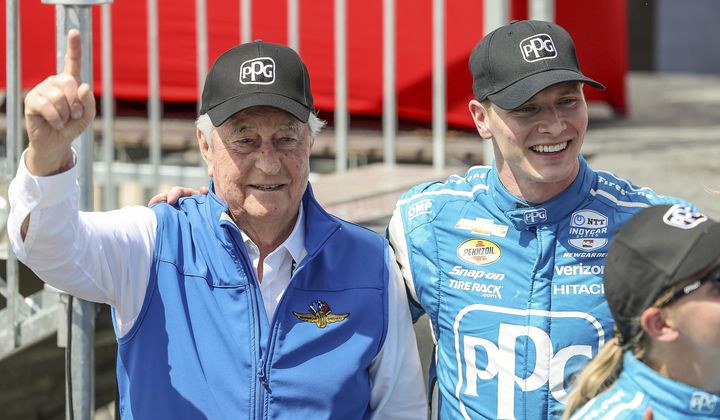 Team Penske driver Josef Newgarden, right, celebrates his victory with team owner Roger Penske after the IndyCar Grand Prix of St. Petersburg auto race, Sunday, March 10, 2024, in St. Petersburg, Fla. Team Penske suffered a humiliating disqualification Wednesday, April 24, when reigning Indianapolis 500 winner Josef Newgarden was stripped of his victory in the season-opening race for manipulating his push-to-pass system. Penske teammate Scott McLaughlin, who finished third in the opener on the downtown streets of St. Petersburg, Florida, was also disqualified. (AP Photo/Mike Carlson, File)
