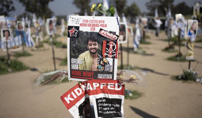 A poster depicting Israeli-American hostage Hersh Goldberg-Polin is displayed in Re&#x27;im, southern Israel at the Gaza border, Feb. 26, 2024, at a memorial site for the Nova music festival site where he was kidnapped to Gaza by Hamas on Oct. 7, 2023. Hamas on Wednesday, April 24, 2023, released a recorded video of an Israeli American still being held by the group. The video was the first sign of life of Hersh Goldberg-Polin since Hamas’ Oct. 7 attack on southern Israel. It was not clear when the video was taken. (AP Photo/Maya Alleruzzo, File)
