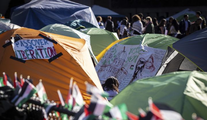 Signs are displayed on tents at the pro-Palestinian demonstration encampment at Columbia University in New York on Wednesday April 24, 2024. (AP Photo/Stefan Jeremiah)