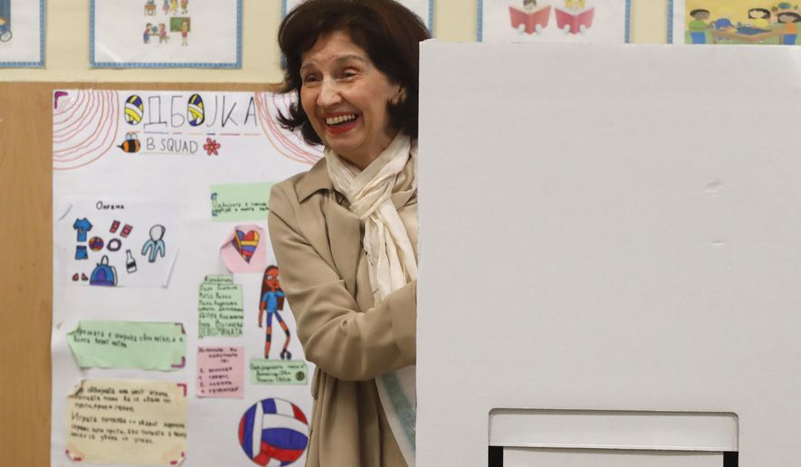 Gordana Siljanovska Davkova, presidential candidate backed by the opposition conservative VMRO-DPMNE party, exits the booth before casting her ballot for the presidential election at a polling station, in Skopje, North Macedonia, on Wednesday, April 24, 2024. People are lining up at pools to cast their votes in a peaceful atmosphere, hoping that the next president will be able to bring the country into the European Union. (AP Photo/Boris Grdanoski)