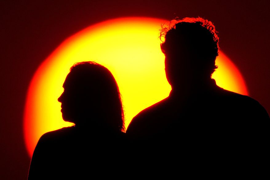 A couple watches the sunset from a park, on July 10, 2021, in Kansas City, Mo. A quarter of U.S. adults over the age of 50 have no retirement savings, according to a new AARP survey — and 70% of people surveyed are worried about prices rising faster than their income. New research from the AARP released Wednesday reveals how a graying America is worrying more and more about how to make ends meet, even as economists and policymakers say the U.S. economy has all but achieved a soft landing after a period of record-high inflation. (AP Photo/Charlie Riedel, File)