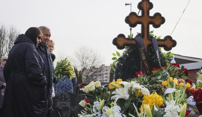 From left, Lyudmila Navalnaya and Anatoly Navalny, parents of Russian opposition leader Alexei Navalny, and Navalny&#x27;s mother-in-law Alla Abrosimova visit the grave of the late Russian opposition leader son on the fortieth day after his death as per Orthodox tradition at the Borisovskoye Cemetery, in Moscow, Russia, Tuesday, March 26, 2024. (AP Photo/Vitaly Smolnikov)