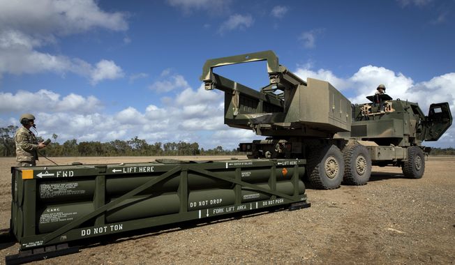 In this image provided by the U.S. Army, U.S. Army Sgt. Ian Ketterling, gunner for Alpha Battery, 1st Battalion, 3rd Field Artillery Regiment, 17th Field Artillery Brigade, prepares the crane for loading the Army Tactical Missile System (ATACMS) on to the High Mobility Artillery Rocket System (HIMARS) in Queensland, Australia, July 26, 2023. U.S. officials say Ukraine for the first time has begun using long-range ballistic missiles, called ATACMS, striking a Russian military airfield in Crimea and Russian troops in another occupied area overnight. (Sgt. 1st Class Andrew Dickson/U.S. Army via AP)