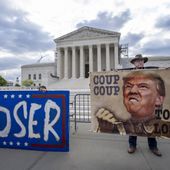Activist Stephen Parlato of Boulder, Colo., right, joins other protesters outside the Supreme Court as the justices prepare to hear arguments over whether Donald Trump is immune from prosecution in a case charging him with plotting to overturn the results of the 2020 presidential election, on Capitol Hill in Washington, Thursday, April 25, 2024. (AP Photo/J. Scott Applewhite)