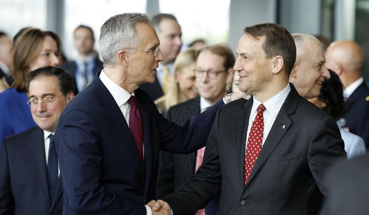 NATO Secretary-General Jens Stoltenberg, left, shakes hands with Poland&#x27;s Foreign Minister Radoslaw Sikorski at a ceremony to mark the 75th anniversary of NATO at NATO headquarters in Brussels, Thursday, April 4, 2024. NATO marked on Thursday 75 years of collective defense across Europe and North America, with its top diplomats vowing to stay the course in Ukraine as better-armed Russian troops assert control on the battlefield. (AP Photo/Geert Vanden Wijngaert)