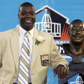 FILE - Former Washington Redskins cornerback Darrell Green stands next to his bronze bust at the Pro Football Hall of Fame in Canton, Ohio, Aug. 2, 2008. The Washington Commanders are retiring Hall of Fame cornerback Darrell Green’s No. 28 next season, the latest step in the organization&#x27;s efforts to honor players of the past since new ownership took over last summer. The team announced Thursday, April 25, 2024, that Green will be the fifth player in franchise history to receive that honor. (AP Photo/Kiichiro Sato, File)