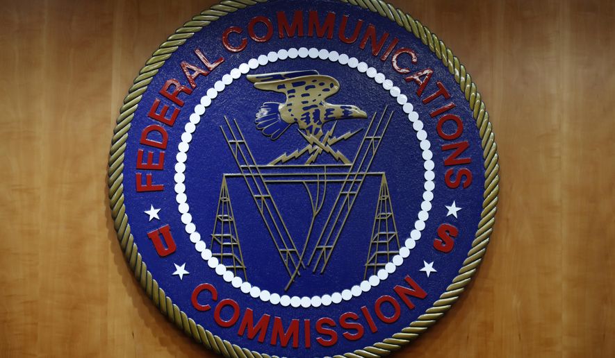 The seal of the Federal Communications Commission (FCC) is seen before an FCC meeting to vote on net neutrality, Dec. 14, 2017, in Washington. The FCC on Thursday, April 25, 2024 restored “net neutrality” rules that prevent broadband internet providers such as Comcast and AT&amp;T from favoring some sites and apps over others.. (AP Photo/Jacquelyn Martin, File)