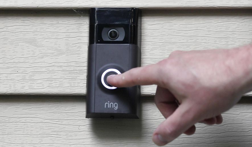 FILE - A person pushes the doorbell on his Ring doorbell camera, July 16, 2019, at his home in Wolcott, Conn. The Federal Trade Commission is sending $5.6 million in refunds to consumers as part of a settlement with Amazon-owned Ring, which was charged with failing to protect private video footage from outside access. (AP Photo/Jessica Hill, File)
