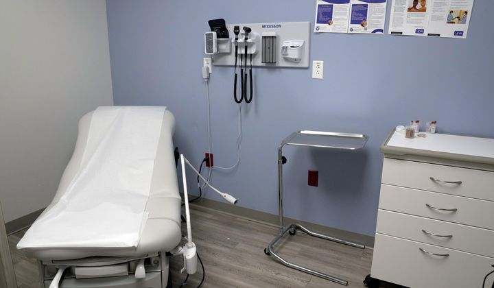 An exam room is seen inside Planned Parenthood on March 10, 2023. Republican attorneys general from 17 states filed a lawsuit Thursday, April 25, 2024, challenging new federal rules entitling workers to time off and other accommodations for abortions, calling the rules an illegal interpretation of a 2022 federal law. (AP Photo/Jeff Roberson)
