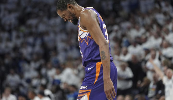Phoenix Suns forward Kevin Durant walks across the court during the first half of Game 1 of an NBA basketball first-round playoff series against the Minnesota Timberwolves, Saturday, April 20, 2024, in Minneapolis. (AP Photo/Abbie Parr)
