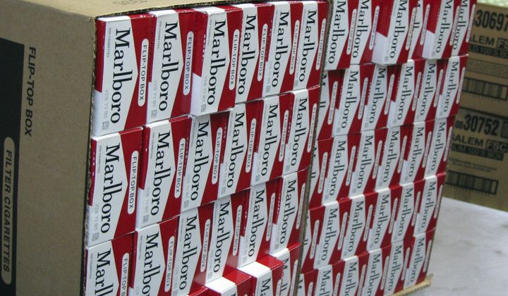 This July 29, 2013, photo shows a case of freshly-stamped Marlboro cigarette cartons at M. Amundson Cigar &amp; Candy Co. in Minneapolis. Smokers in Minneapolis will pay some of the highest cigarette prices in the country after the City Council voted unanimously Thursday, april 25, 2024 to impose a minimum retail price of $15 per pack to promote public health. (Mark Zdechlik/Minnesota Public Radio via AP, file)