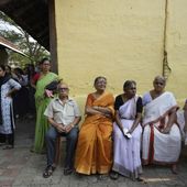 Elderly voters sit as others stand in a queue to vote during the second round of voting in the six-week-long national election near Palakkad, in Indian southern state of Kerala, Friday, April 26, 2024. (AP Photo/Manish Swarup)