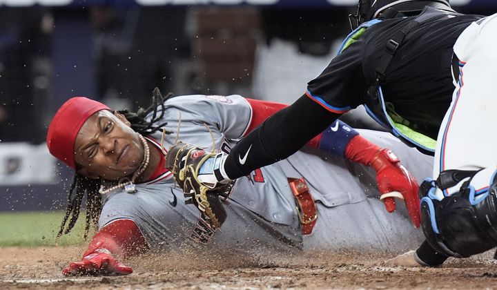Miami Marlins catcher Nick Fortes, right, is unable to tag out Washington Nationals&#x27; CJ Abrams as he scores during the eighth inning of a baseball game, Friday, April 26, 2024, in Miami. Abrams and Trey Lipscomb scored on a single by Joey Meneses. (AP Photo/Wilfredo Lee) **FILE**