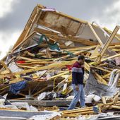 Gopala Penmetsa walks past his house after it was leveled by a tornado near Omaha, Neb., on Friday, April 26, 2024. (Chris Machian/Omaha World-Herald via AP)