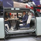 Visitors sit inside a Zeekr Mix car during the China Auto Show in Beijing, China, Friday, April 26, 2024. China&#x27;s vision of the future of the automobile electrified and digitally connected is on display at the ongoing Beijing auto show. (AP Photo/Tatan Syuflana)