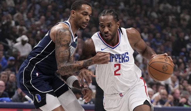 Dallas Mavericks forward P.J. Washington, left, defends as Los Angeles Clippers&#x27; Kawhi Leonard (2) works to the basket during the first half of Game 2 of an NBA basketball first-round playoff series Friday, April 26, 2024, in Dallas. (AP Photo/Tony Gutierrez)