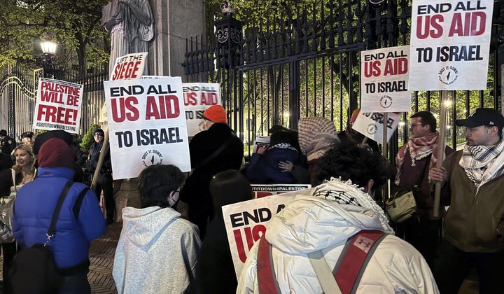 Pro-Palestinian protesters demonstrate outside the main gate at Columbia University, in New York, early Friday, April 26, 2024. (AP Photo/Aaron Morrison)