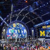Michigan Football players stand on stage during the second round of the NFL football draft, Friday, April 26, 2024, in Detroit. (AP Photo/Paul Sancya)