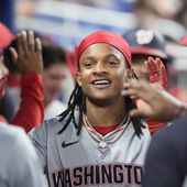 Washington Nationals&#x27; CJ Abrams is congratulated by teammates after he and Trey Lipscomb scored on a single by Joey Meneses during the eighth inning of a baseball game against the Miami Marlins, Friday, April 26, 2024, in Miami. (AP Photo/Wilfredo Lee)