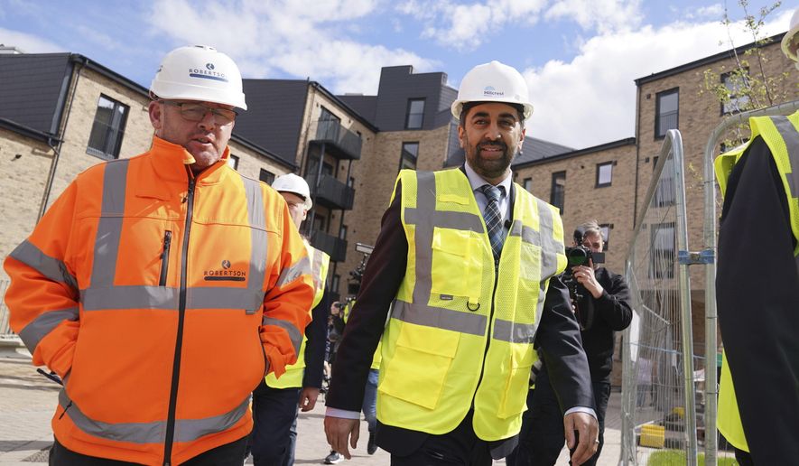 Scotland&#x27;s First Minister Humza Yousaf, centre, visits the Hillcrest Homes housing development in Dundee, Scotland, Friday April 26, 2024. (Andrew Milligan/PA via AP)