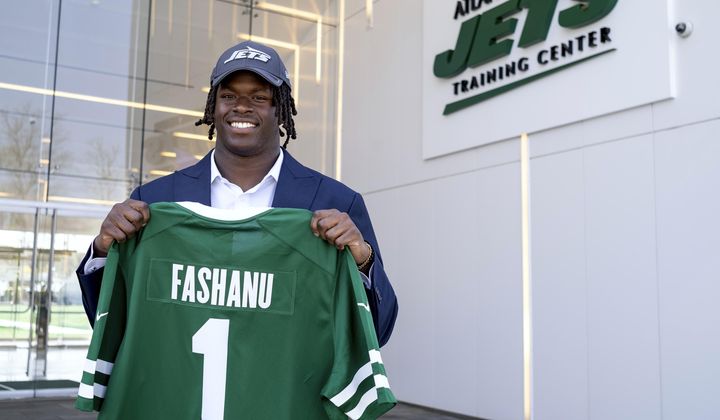 New York Jets offensive tackle Olu Fashanu holds his jersey at the team&#x27;s training facility in Florham Park, N.J., Friday, April 26, 2024. Fashanu, a Penn State offensive tackle, was selected at No. 11 overall by New York after the Jets traded down one spot Thursday night. (AP Photo/Craig Ruttle)