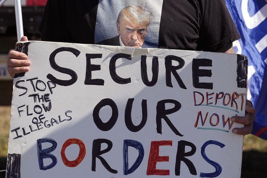 Phill Cady wears a T-shirt with a photo of former President Donald Trump, who is running for reelection, as he holds a sign during a "Take Our Border Back" rally on Feb. 3, 2024, in Quemado, Texas. Trump has moved anti-immigration sentiment to center stage in U.S. politics. (AP Photo/Eric Gay) **FILE**