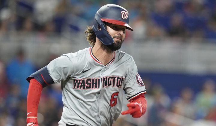 Washington Nationals&#x27; Jesse Winker (6) runs to first base after hitting a single during the sixth inning of a baseball game against the Miami Marlins, Saturday, April 27, 2024, in Miami. (AP Photo/Marta Lavandier)