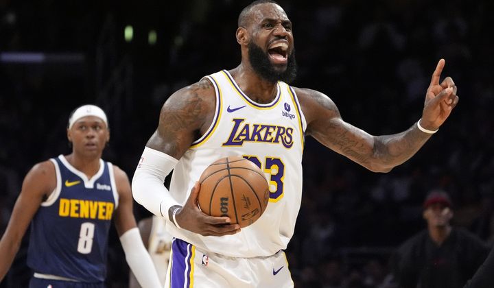 Los Angeles Lakers forward LeBron James, right, questions an out of bounds call as Denver Nuggets forward Peyton Watson looks on during the first half in Game 4 of an NBA basketball first-round playoff series Saturday, April 27, 2024, in Los Angeles. (AP Photo/Mark J. Terrill)