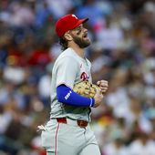 Philadelphia Phillies first basemen Bryce Harper reacts after a collision at first with San Diego Padres&#x27; Jurickson Profar during the second inning of a baseball game, Friday, April 26, 2024, in San Diego. (AP Photo/Brandon Sloter)
