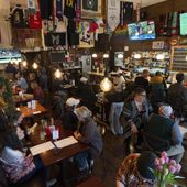 Customers eat and watch college women&#x27;s lacrosse and beach volleyball matches on big-screen TVs at The Sports Bra sports bar on Wednesday, April 24, 2024, in Portland, Ore. (AP Photo/Jenny Kane)