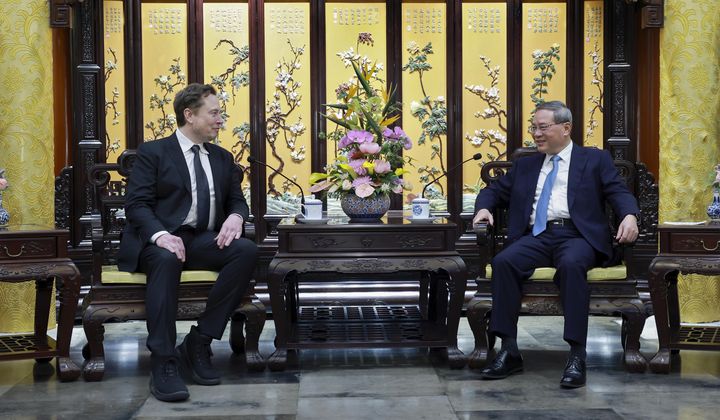 In this photo released by Xinhua News Agency, visiting Tesla founder and CEO Elon Musk, left, meets with Chinese Premier Li Qiang in Beijing, Sunday, April 28, 2024. Musk met with a top government leader in the Chinese capital Sunday, just as the nation&#x27;s carmakers are showing off their latest electric vehicle models at the Beijing auto show. (Wang Ye/Xinhua via AP)