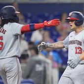 Washington Nationals&#x27; CJ Abrams (5) congratulates Nick Senzel (13) after Senzel hit a home run scoring Abrams during the fourth inning of a baseball game against the Miami Marlins, Sunday, April 28, 2024, in Miami. (AP Photo/Wilfredo Lee)
