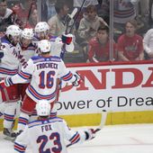 New York Rangers left wing Artemi Panarin, center, celebrates with teammates after scoring a goal during the third period in Game 4 of an NHL hockey Stanley Cup first-round playoff series against the Washington Capitals, Sunday, April 28, 2024, in Washington. (AP Photo/Tom Brenner)