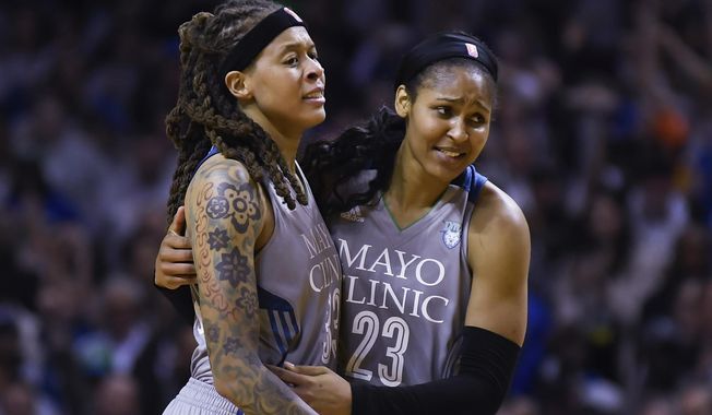 Minnesota Lynx guard Seimone Augustus (33) and forward Maya Moore (23) embrace after Game 5 of the team&#x27;s WNBA Finals against the Los Angeles Sparks, Oct. 4, 2017 in Minneapolis. The Women’s Basketball Hall of Fame had a huge Minnesota feel to it with the induction of Moore and Augustus getting enshrined on Saturday, April 25, 2024. (Aaron Lavinsky/Star Tribune via AP, File)
