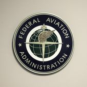 A Federal Aviation Administration sign hangs in the tower at John F. Kennedy International Airport in New York, March 16, 2017. Congressional negotiators have agreed on a $105 billion bill designed to improve the safety of air travel after a series of close calls between planes at the nation’s airports. (AP Photo/Seth Wenig, File)