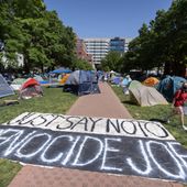 A banner reading &quot;Just Say No To Genocide Joe&quot; is unfurled on the ground at an encampment by students protesting against the Israel-Hamas war at George Washington University on Monday, April 29, 2024, in Washington. (AP Photo/Mark Schiefelbein)