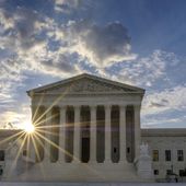 FILE - The sun flares in the camera lens as it rises behind the U.S. Supreme Court building in Washington, June 25, 2017. The Supreme Court will hear an appeal from a Vista, Calif., CBD hemp oil company fighting a lawsuit from a truck driver who says he got fired after using a product falsely advertised as being free from the active ingredient in marijuana.(AP Photo/J. David Ake, File)