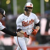 Baltimore Orioles&#x27; Gunnar Henderson, right, celebrates after his home run with third base coach Tony Mansolino, left, during the first inning of a baseball game against the New York Yankees, Monday, April 29, 2024, in Baltimore. (AP Photo/Nick Wass)