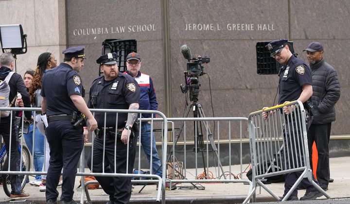 New York City Police officers set up barricades around gathered members of the press outside the Columbia University campus, Tuesday, April 30, 2024, in New York. (AP Photo/Mary Altaffer)