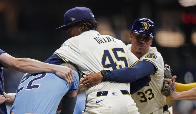 Milwaukee Brewers&#x27; Abner Uribe (45) is held back by Quintin Berry (33) as he fights with Tampa Bay Rays&#x27; Jose Siri (22) during the eighth inning of a baseball game Tuesday, April 30, 2024, in Milwaukee. (AP Photo/Aaron Gash) **FILE**