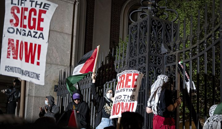 Pro-Palestianian protesters gather near a main gate at Columbia University in New York, Tuesday, April 30, 2024, just before New York City police officers cleared the area after a building was taken over by protesters earlier in the day. The building and a tent encampment were cleared during the operation. (AP Photo/Craig Ruttle)